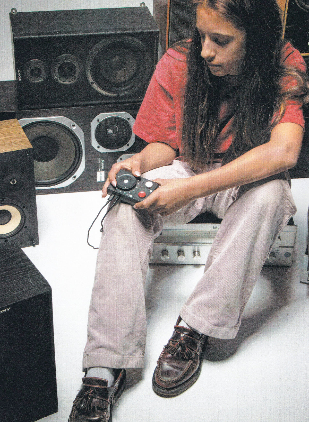 Person holding the NTS Radio Player in front of speakers